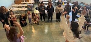 group of playgroup leaders standing in a circle at a workshop